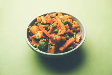 Mix vegetable curry - Indian main course recipe contains Carrots, cauliflower, green peas and beans, baby corn, capsicum and paneer/cottage cheese with traditional masala and curry, selective focus