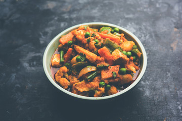 Mix vegetable curry - Indian main course recipe contains Carrots, cauliflower, green peas and beans, baby corn, capsicum and paneer/cottage cheese with traditional masala and curry, selective focus