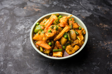 Mix vegetable curry - Indian main course recipe contains Carrots, cauliflower, green peas and beans, baby corn, capsicum and paneer/cottage cheese with traditional masala and curry, selective focus