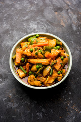 Mix vegetable curry - Indian main course recipe contains Carrots, cauliflower, green peas and beans, baby corn, capsicum and paneer/cottage cheese with traditional masala and curry, selective focus