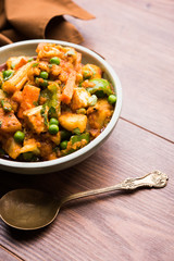 Mix vegetable curry - Indian main course recipe contains Carrots, cauliflower, green peas and beans, baby corn, capsicum and paneer/cottage cheese with traditional masala and curry, selective focus