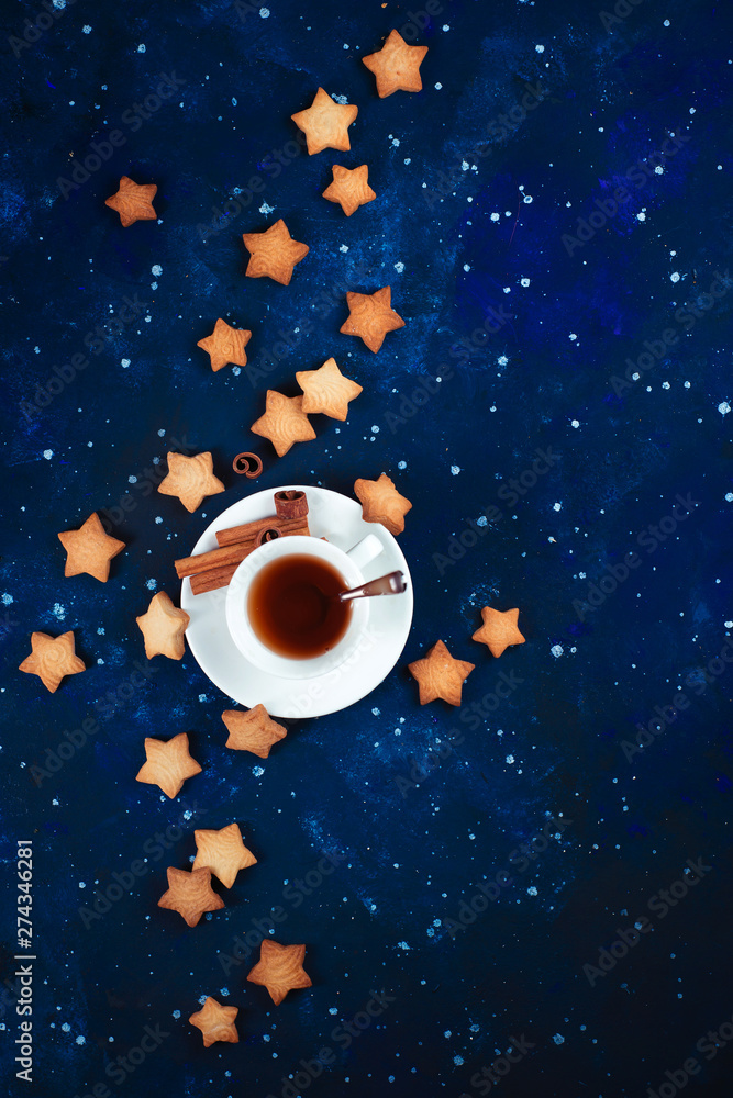 Wall mural teatime with star-shaped cookies. white porcelain cups on a starry sky background. astronomy and con