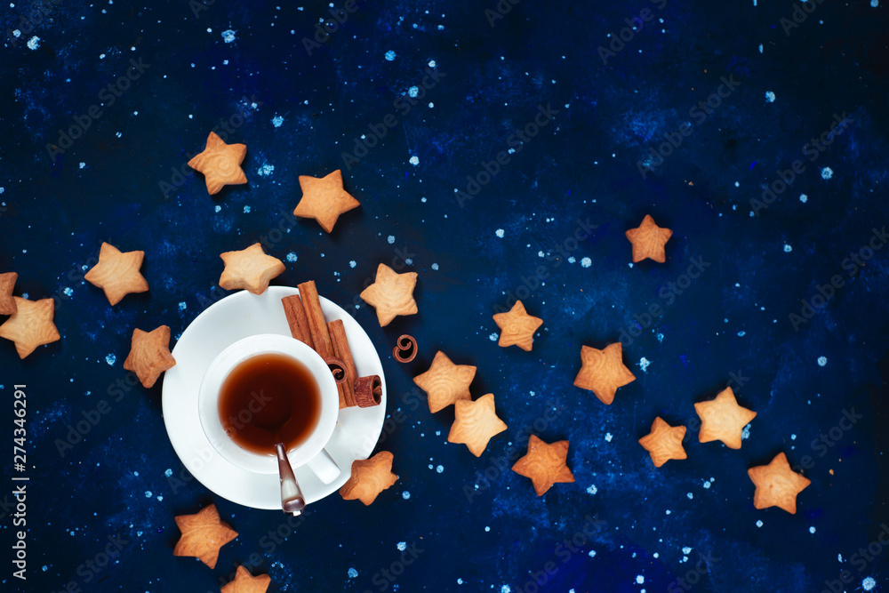 Wall mural astronomy and constellation flat lay with copy space. teatime with star-shaped cookies. white porcel