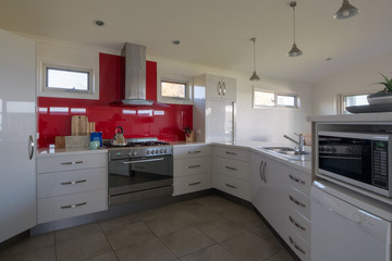 Kitchen with red glass spashbacks