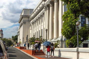 People walking in front of National Museum, Manila, Philippines, June 8, 2019