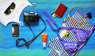 colorful summer female fashion outfit flat-lay. Top view. Summer fashion, holiday, striped shirt, swimsuit, mobile phone, medications. - 274348426