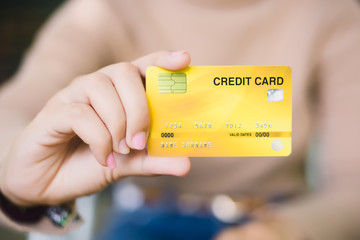 Young female holding credit card, Online shopping or paying concept.