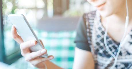 Women's hands are using mobile phones.