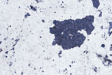 White paint on the old asphalt surface close up. Blue color abstract background 