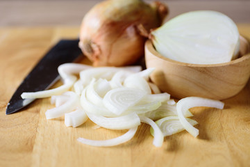 Fototapeta na wymiar Sliced onion on wooden board preparing for cooking