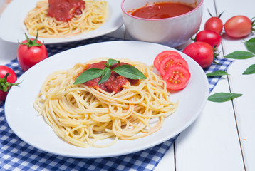 Spaghetti pasta with and tomato sauce on wood background