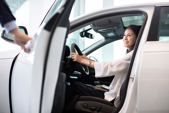 Happy mature woman taking a test drive