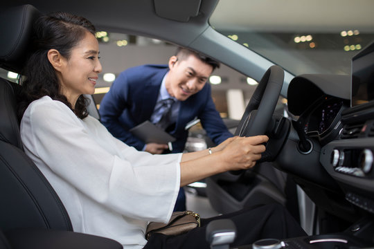 Happy mature woman taking a test drive