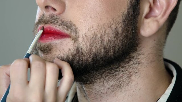 Bearded metrosexual man gettinng makeup