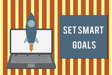 Writing note showing Set Smart Goals. Business concept for giving criteria to guide in the setting of objectives Launching rocket up laptop Startup Developing goal objective