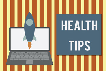 Writing note showing Health Tips. Business concept for advice or information given to be helpful in being healthy Launching rocket up laptop Startup Developing goal objective