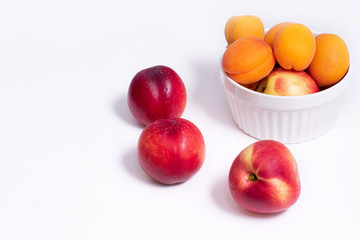 Group of whole nectarine and apricots fruit isolated on white background