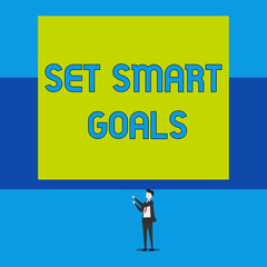 Word writing text Set Smart Goals. Business photo showcasing giving criteria to guide in the setting of objectives Isolated view young man standing pointing upwards two hands big rectangle
