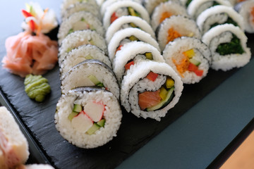 close up assorted sushi rolls, setup nicely on a table