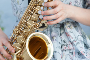 The fingers are ready to play the piano keys and saxophone buttons