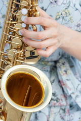 The fingers are ready to play the piano keys and saxophone buttons