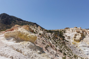 view of the Caldera of the volcano on Nisyros, a huge crater with snow-white sediments, sulfur crystals, from a height, the landscape around resembles a desert