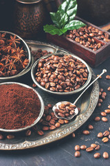 Roasted coffee beans with green leaves, toned photo