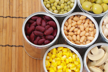 Canned food on bamboo mat background.