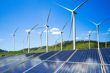 Solar energy panel photovoltaic cell and wind turbine farm power generator in nature landscape for...