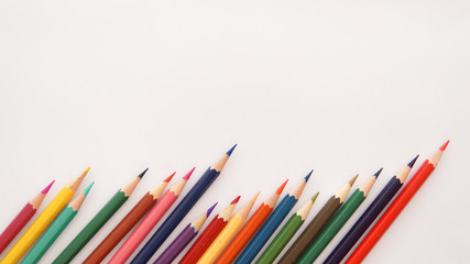 colored pencils on white background with copy space