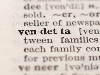 Dictionary definition of word vendetta, selective focus.