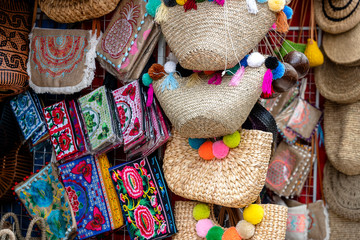 Famous Balinese rattan eco bags in a local souvenir market on street in Ubud, Bali, Indonesia. Handicrafts and souvenir shop display