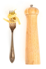 Italian pasta design elements. A fork with pappardelle, shot from above on a white background with a pepper mill and a place for text