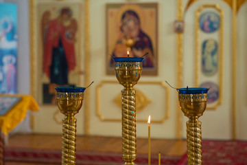 Lamps and candles in front of the altar of an Orthodox church