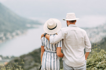 Summer photo shoot at sunset in the Bay of Kotor. Wedding love story with a beautiful couple.
