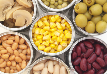 Canned food background, champignons, olives, beans, peas, corn