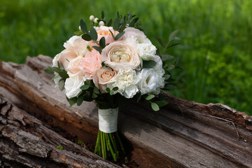 Details of the morning of the wedding day.a delicate wedding bouquet of white and pink roses and pions. beautiful bridal  bouquet outdoors