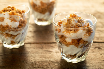 Three portions of Yogurt and crumbled amaretti biscuits in glasses