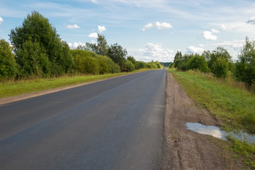 Fototapeta na wymiar Country asphalt highway stretching away on a summer day