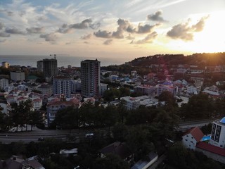 Fototapeta premium View from the camera drone at sunset in the resort town,mountains,clouds