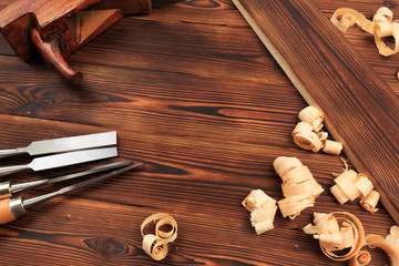 chisels plane and sawdust on a wooden table.