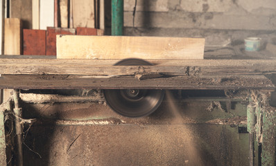 Carpentry machine with a piece of wood.