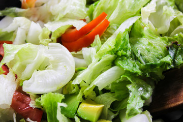 Healthy vegetable salad of fresh tomato, cucumber, onion, spinach, lettuce and sesame on plate. Diet menu