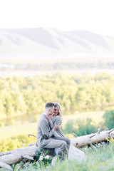 Naklejka na ściany i meble Beautiful love story in the woods. Wedding couple photo shoot in nature.