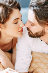 sensual photo shoot on the bed. Stylish young couple in the interior Studio.
