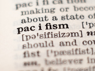 Dictionary definition of word pacifism, selective focus.