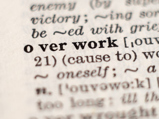 Dictionary definition of word overwork, selective focus.