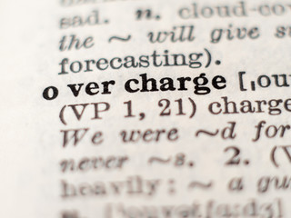 Dictionary definition of word overcharge, selective focus.