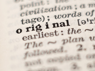 Dictionary definition of word original, selective focus.