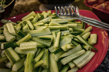 Fresh cucumbers sliced along on a plate. Vegetable slicing for lunch.